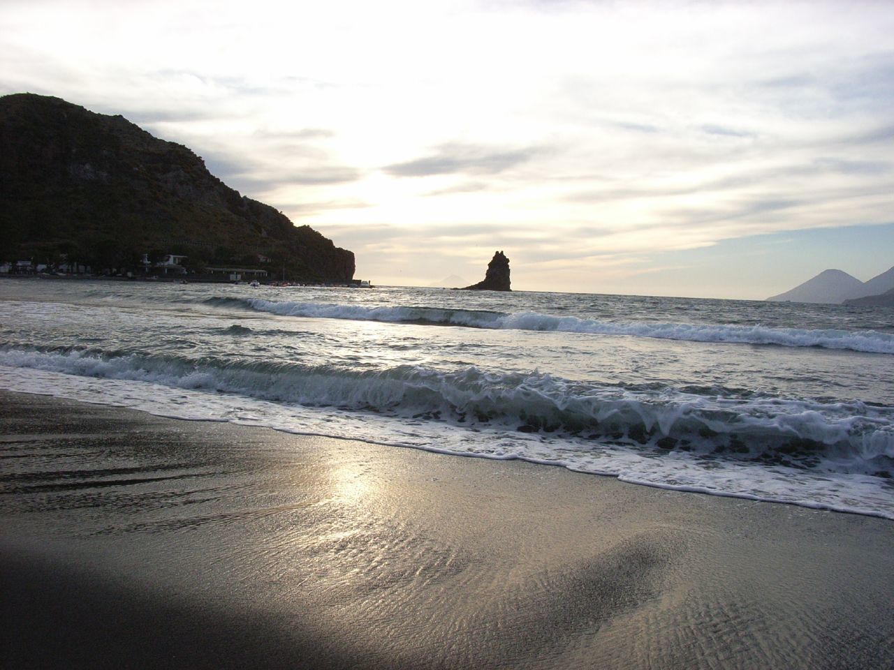 beach with rocky cliffs at sunset