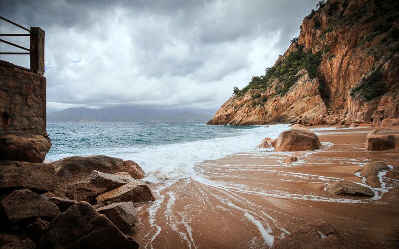 Beach with Rocky Cliffs — Brown