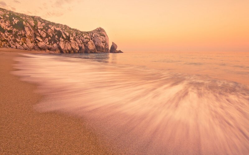 Beach with Rocky Cliffs — Orange