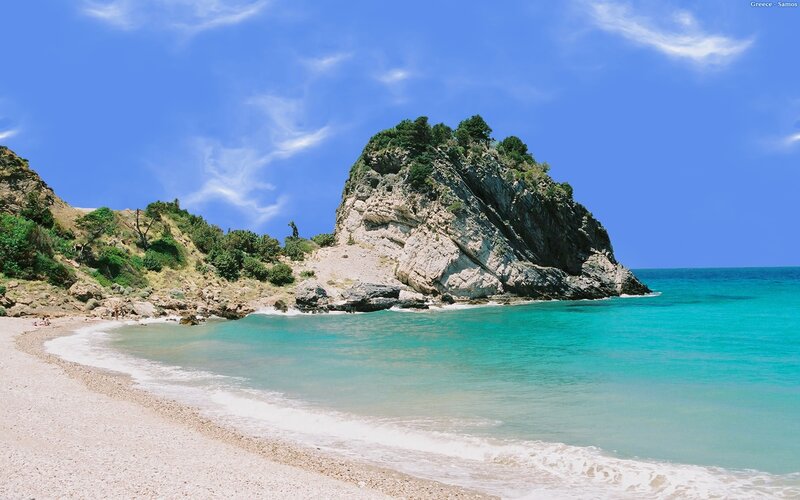 Beach with rocky outcrop in Greece