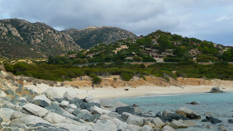 beach with rocky shore and hillside homes