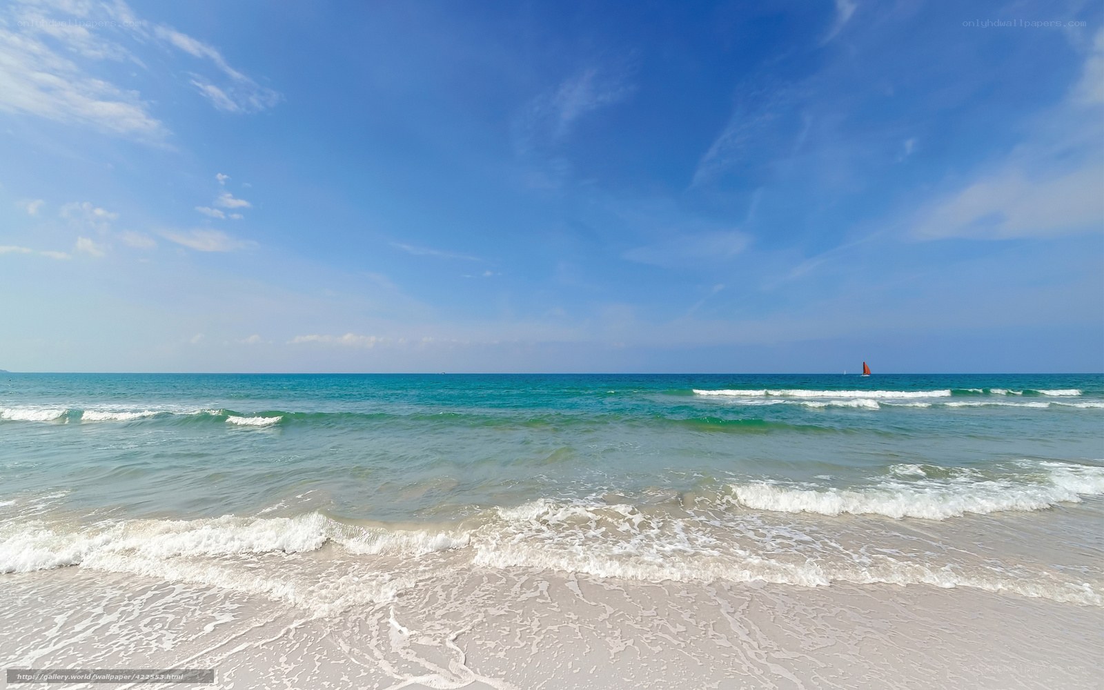 Beach with sailboat in distance