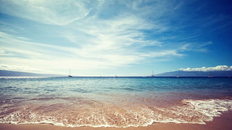 beach with sailboats at sunset