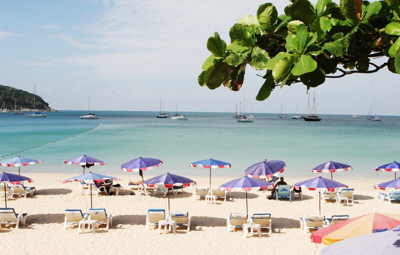 Beach with sailboats in distance