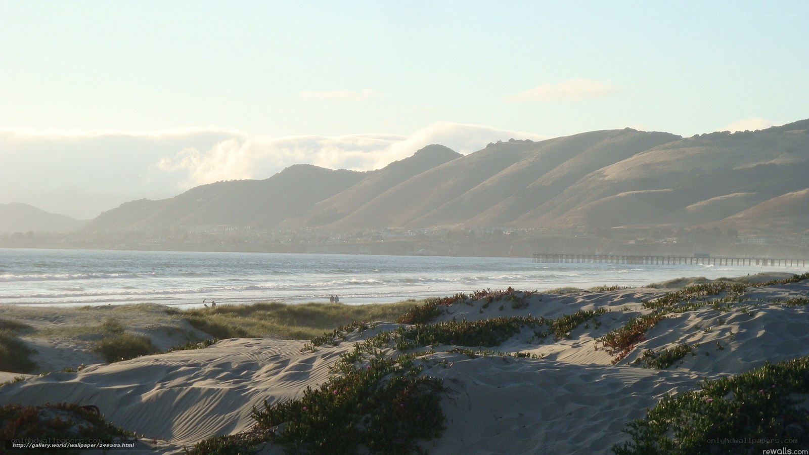 beach with sand dunes and mountains