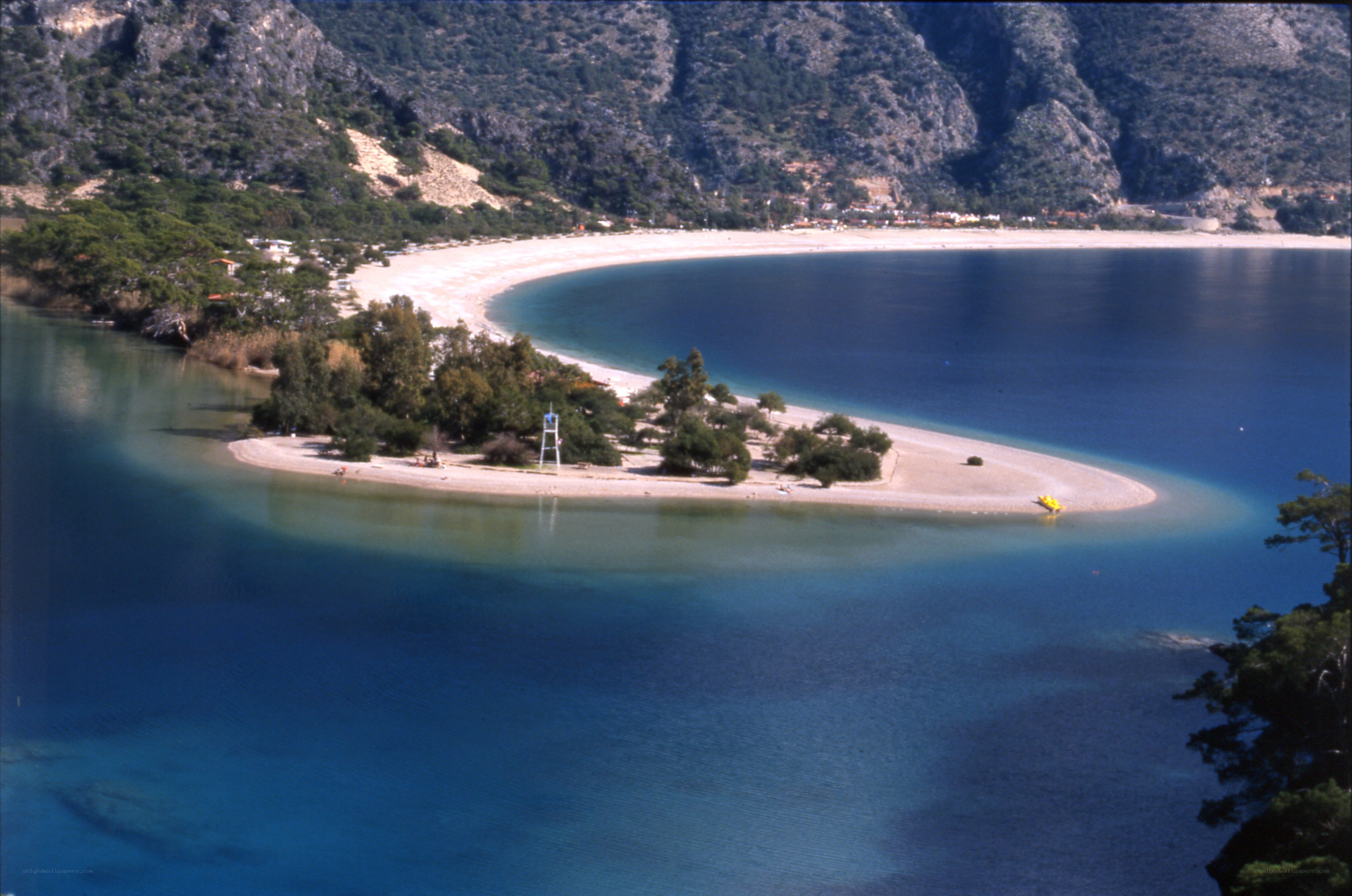 beach with sandbar and mountains