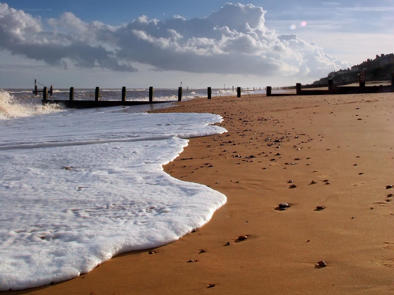 Beach with sea wall and waves
