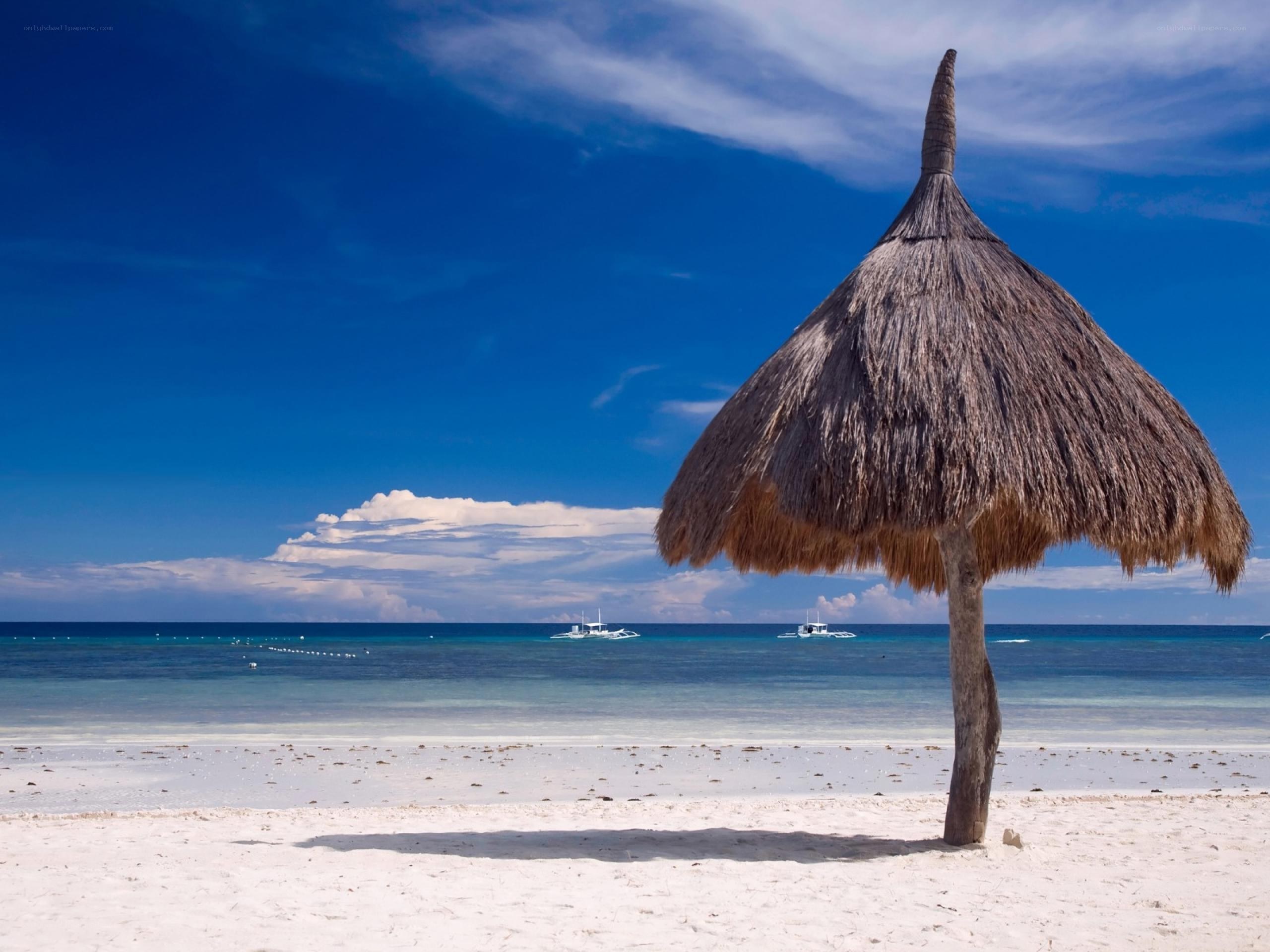 Beach with thatched umbrella