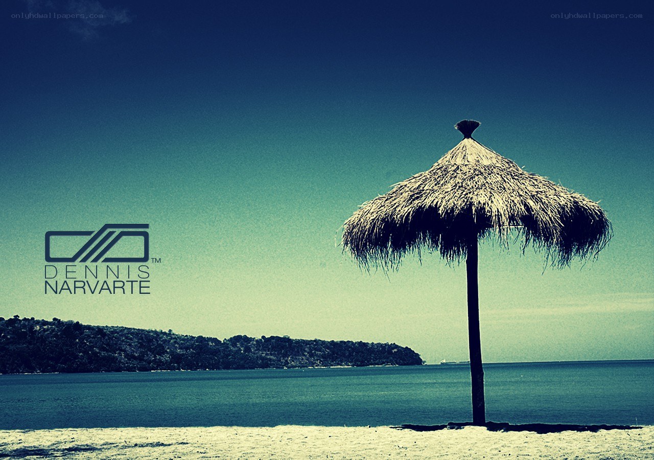 Beach with thatched umbrella