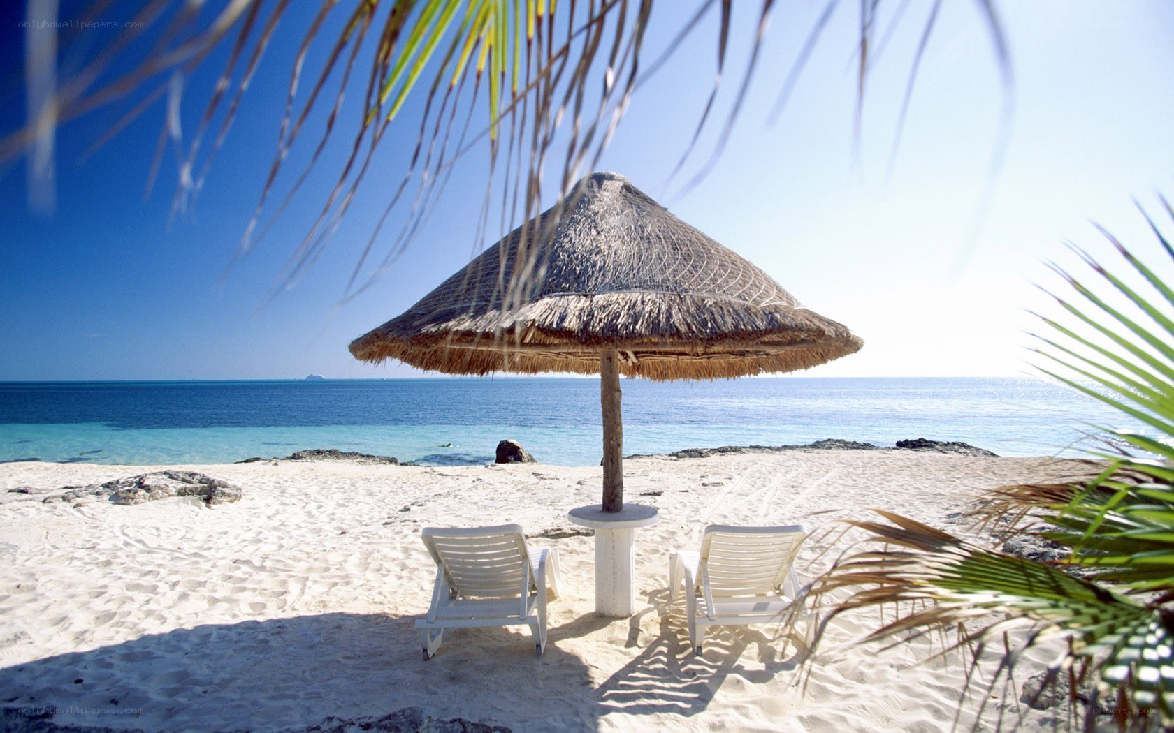 Beach with thatched umbrella
