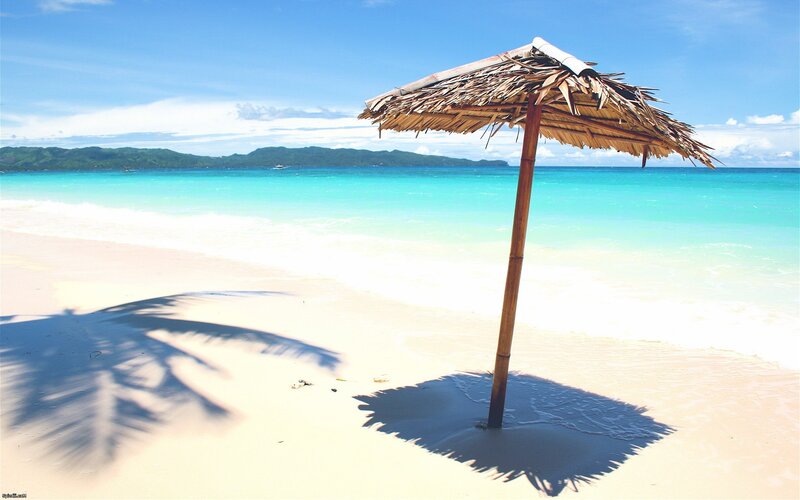 Beach with thatched umbrella