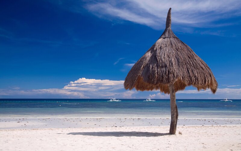 Beach with thatched umbrella