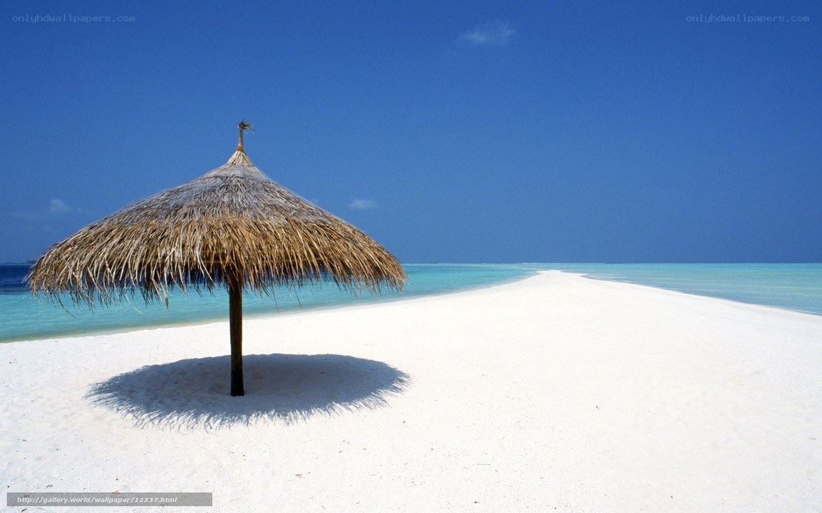 Beach with thatched umbrella