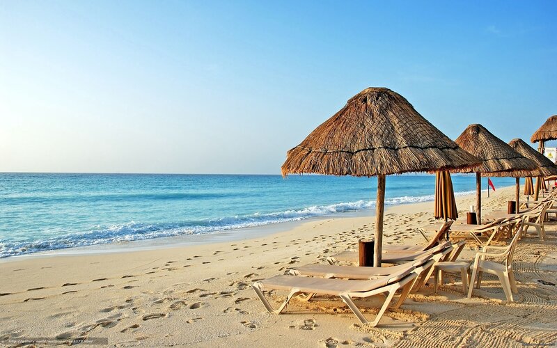 Beach with thatched umbrellas