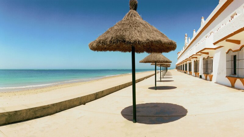 Beach with thatched umbrellas