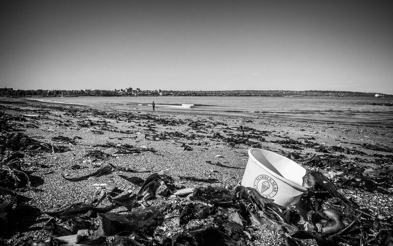 Beach with trash and city view