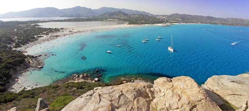 beach with turquoise water and boats