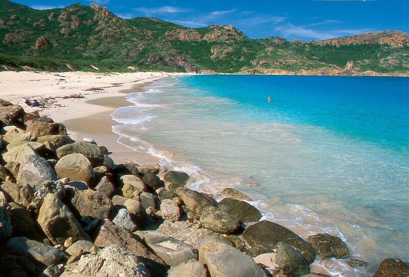 beach with turquoise water and rocky shore