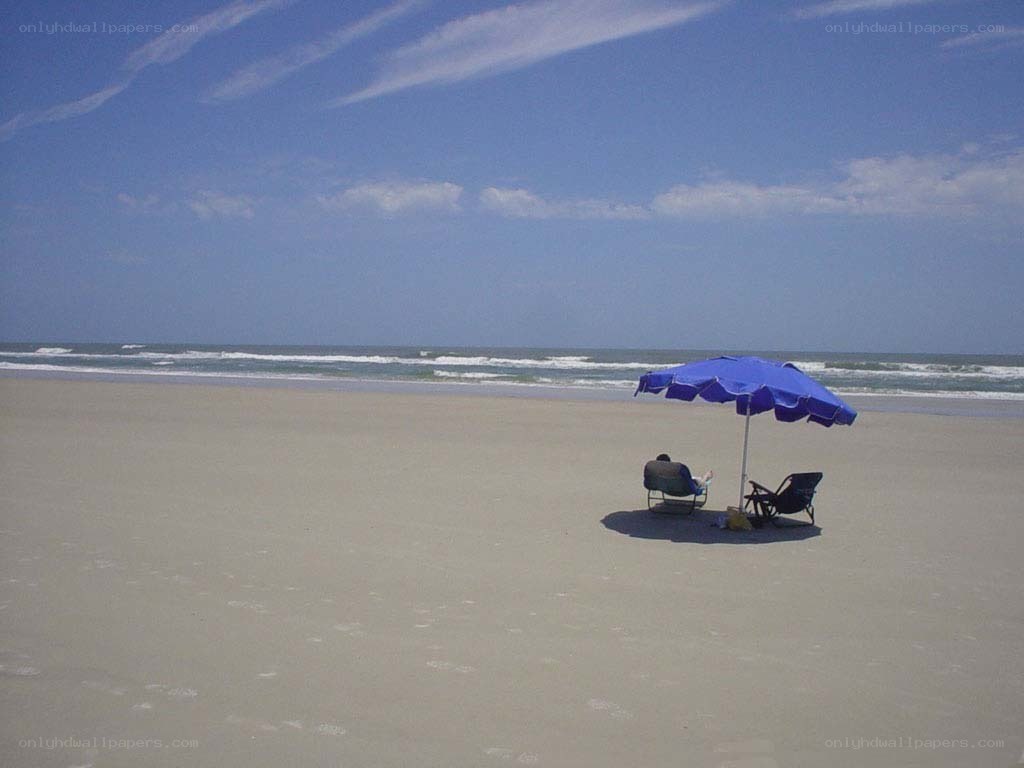 Beach with umbrella and chairs