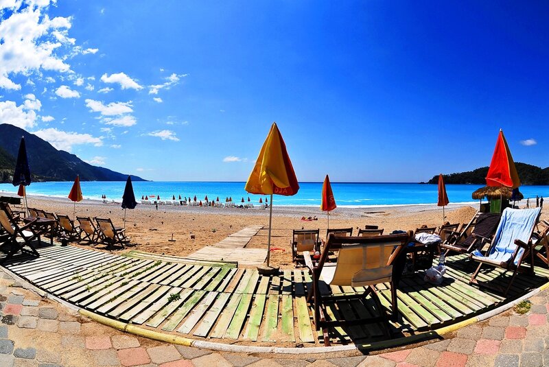 Beach with umbrellas and lounge chairs