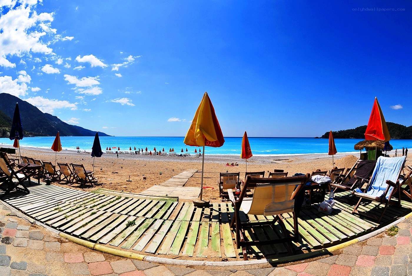 Beach with umbrellas and lounge chairs