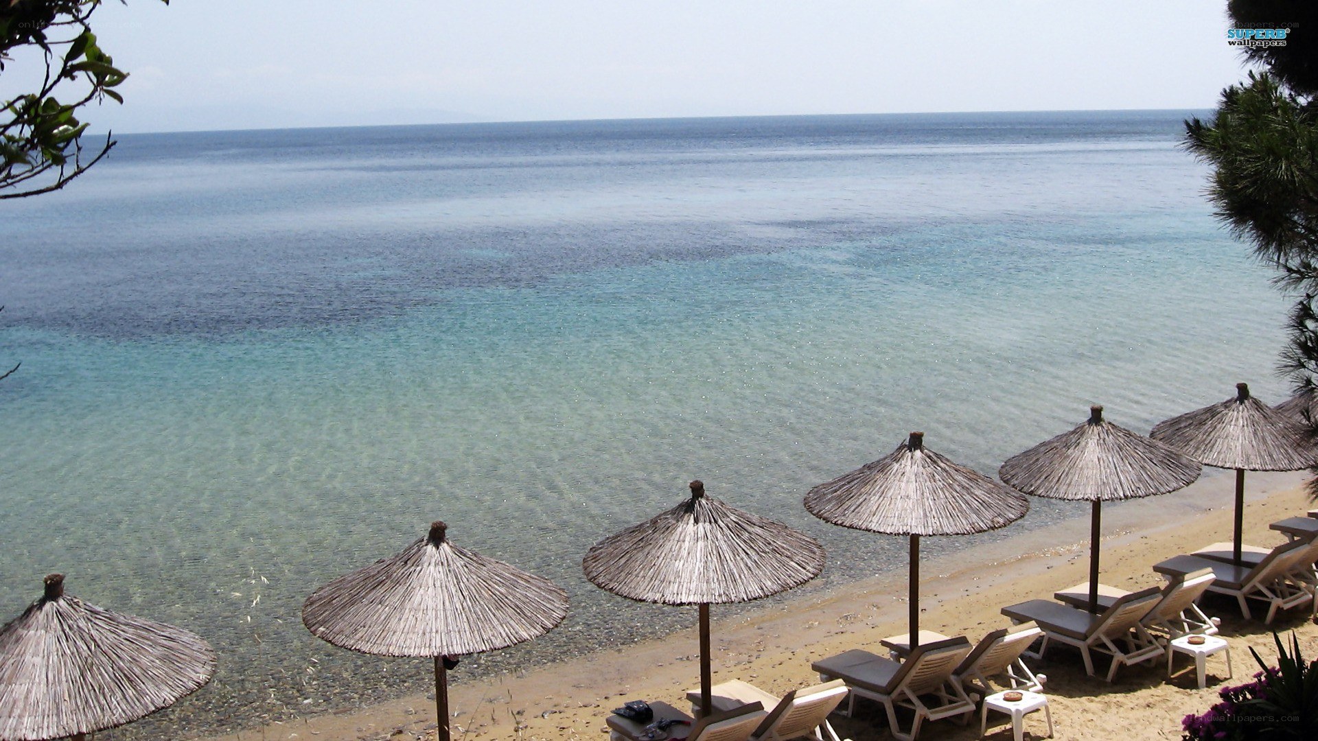 Beach with umbrellas and lounge chairs