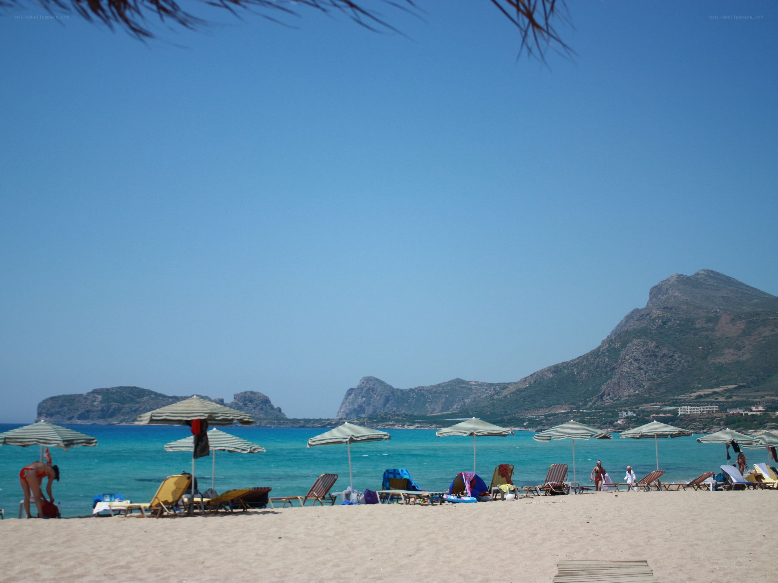 Beach with umbrellas and mountains