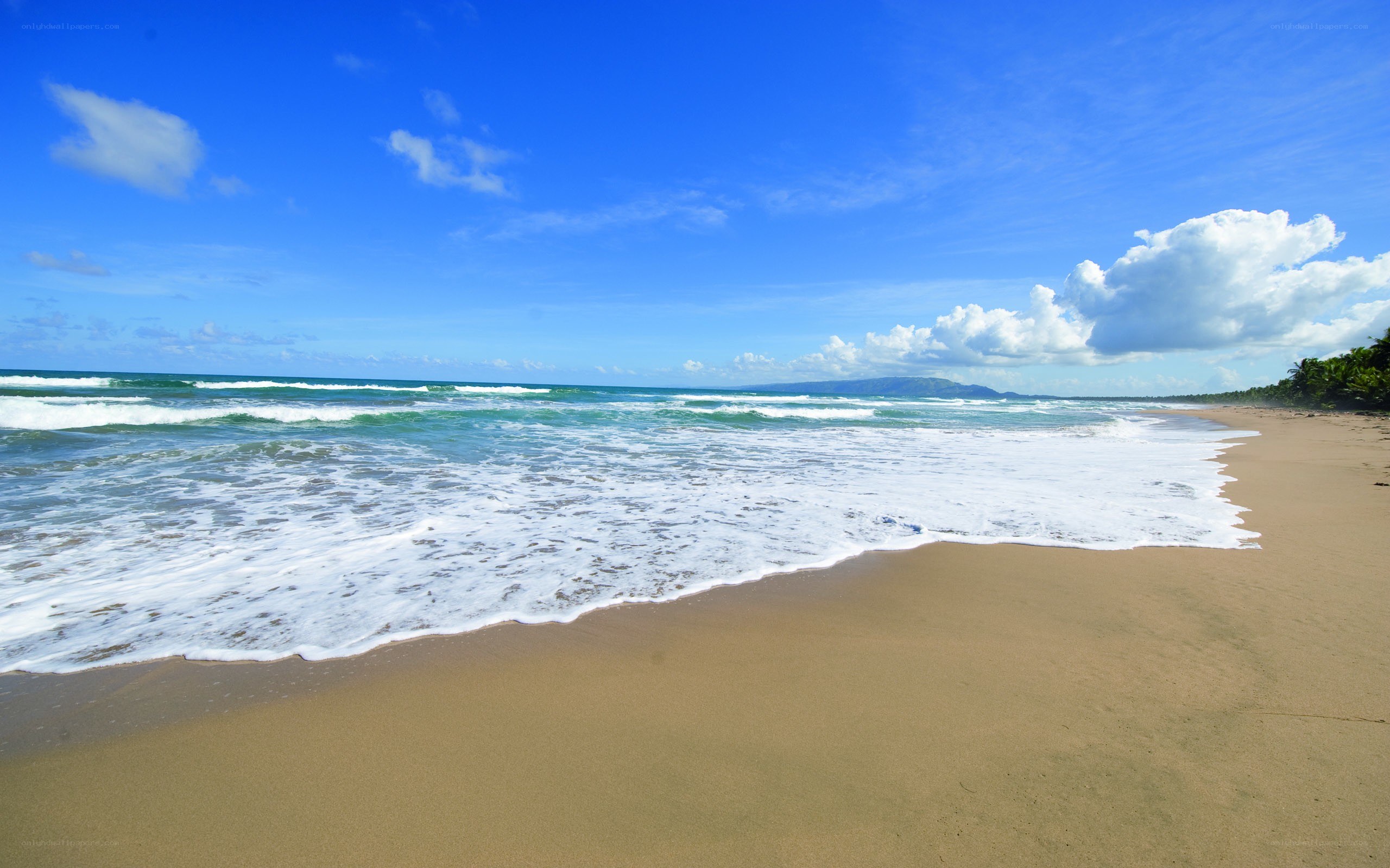 Beach with waves and blue sky