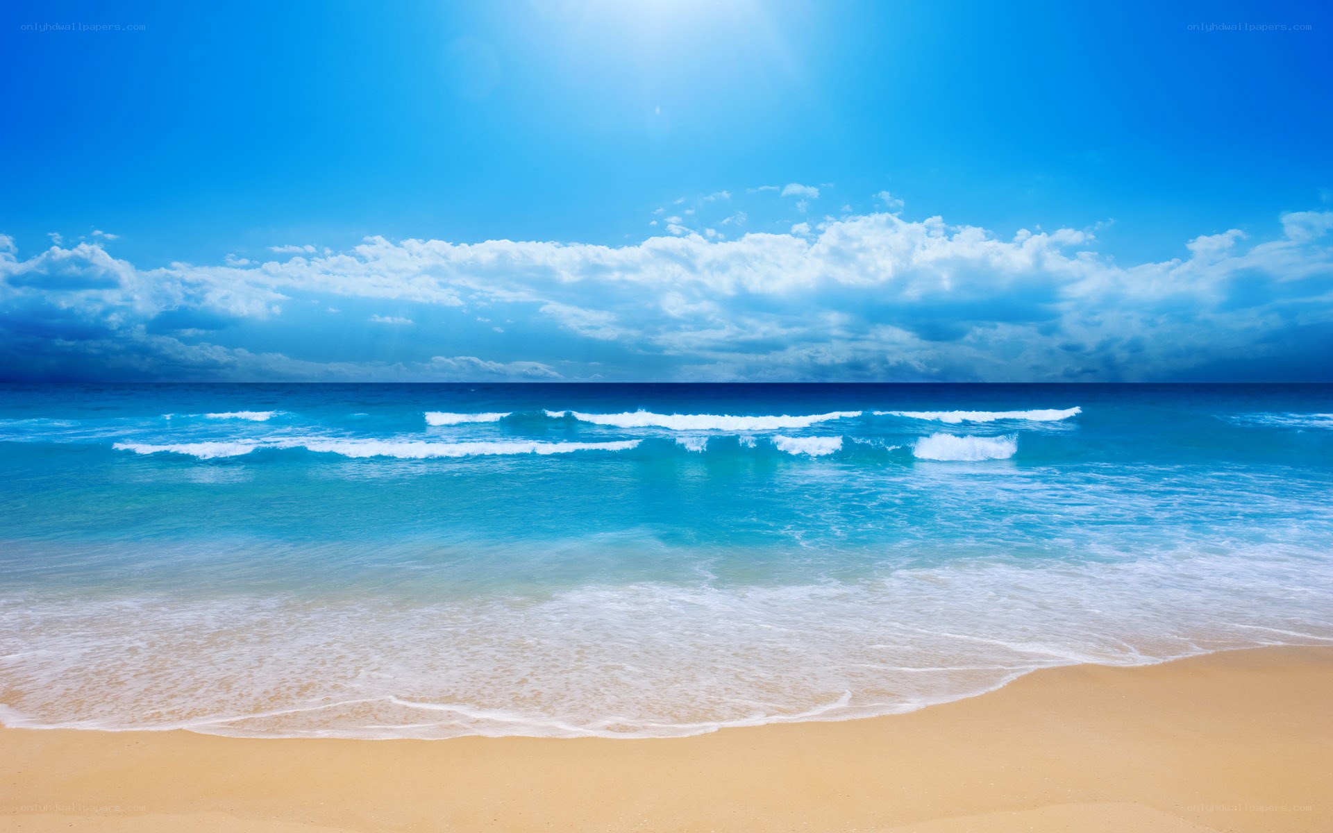 Beach with waves and blue sky