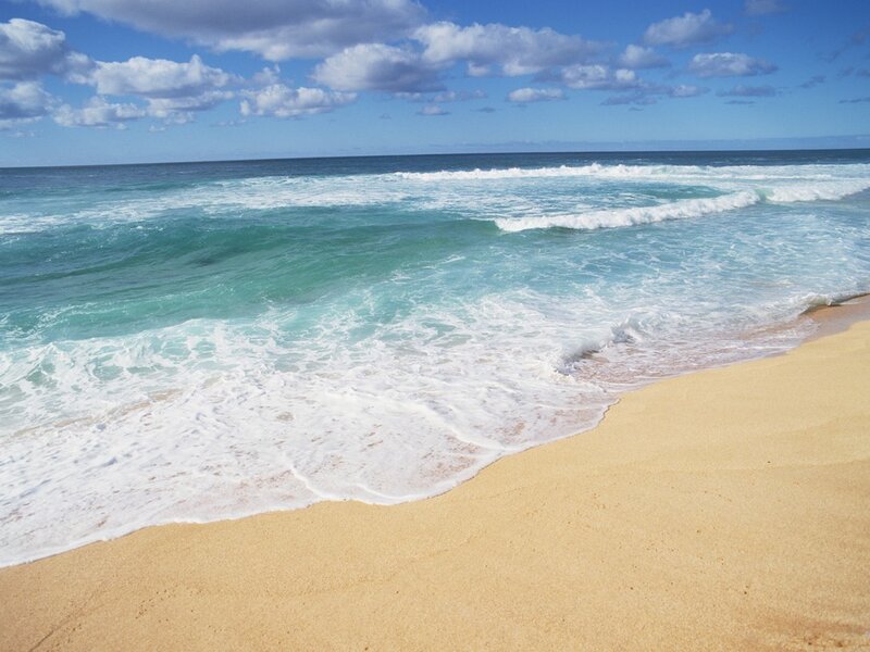 Beach with waves and blue sky