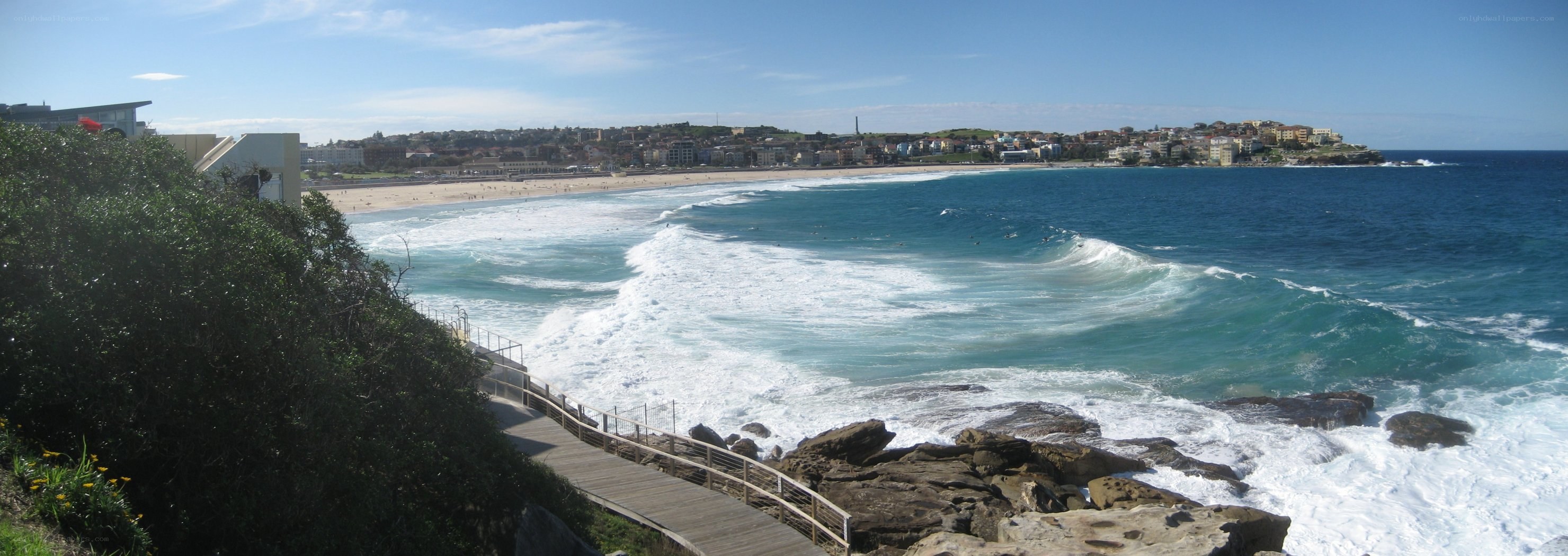 beach with waves and boardwalk