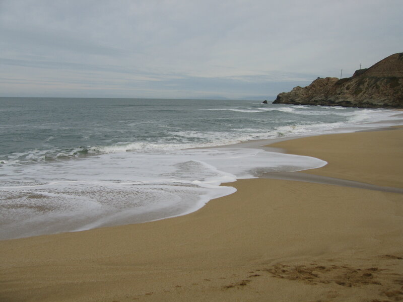 beach with waves and cliffs