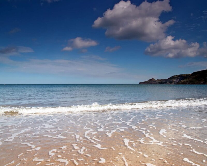 Beach with waves and cliffs