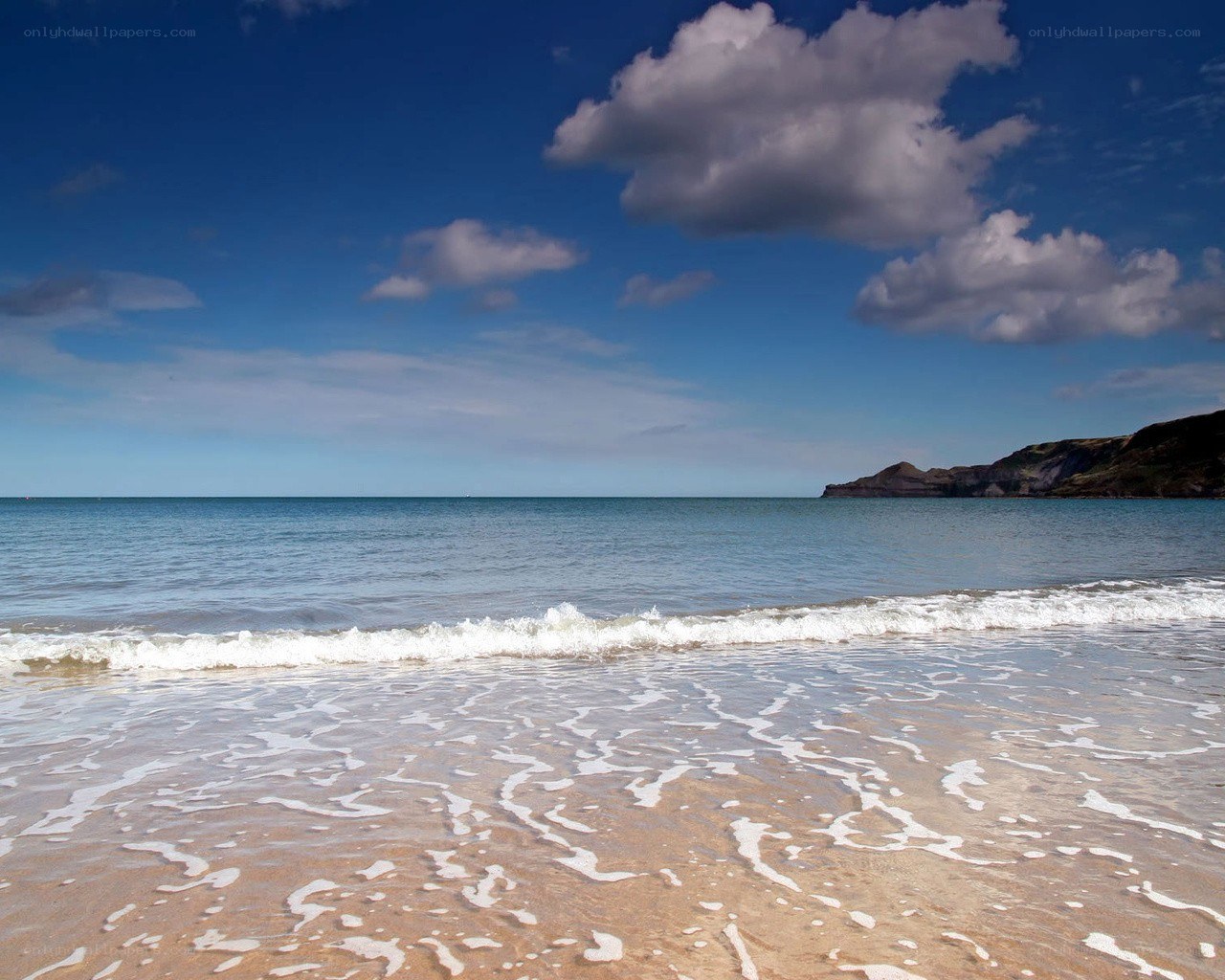 Beach with waves and cliffs