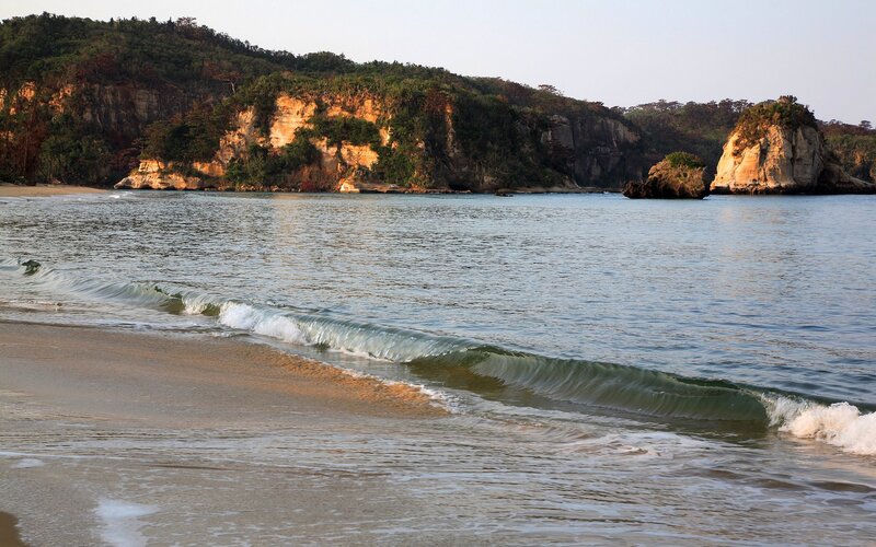Beach with Waves and Cliffs — Blue, Serene, Sunset