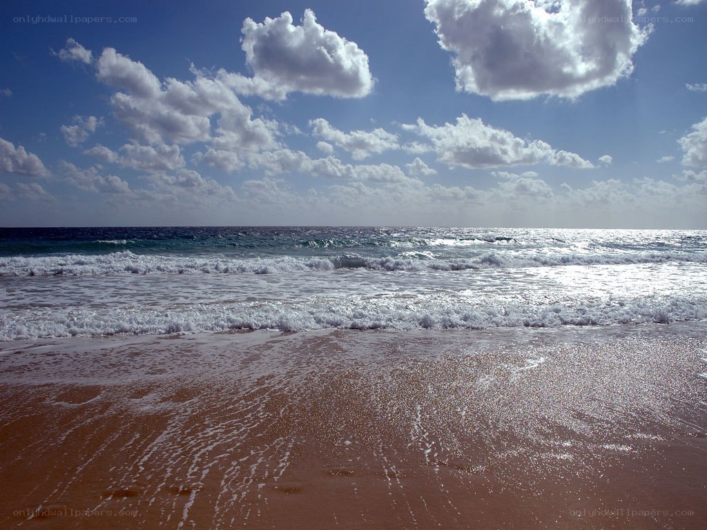 beach with waves and clouds