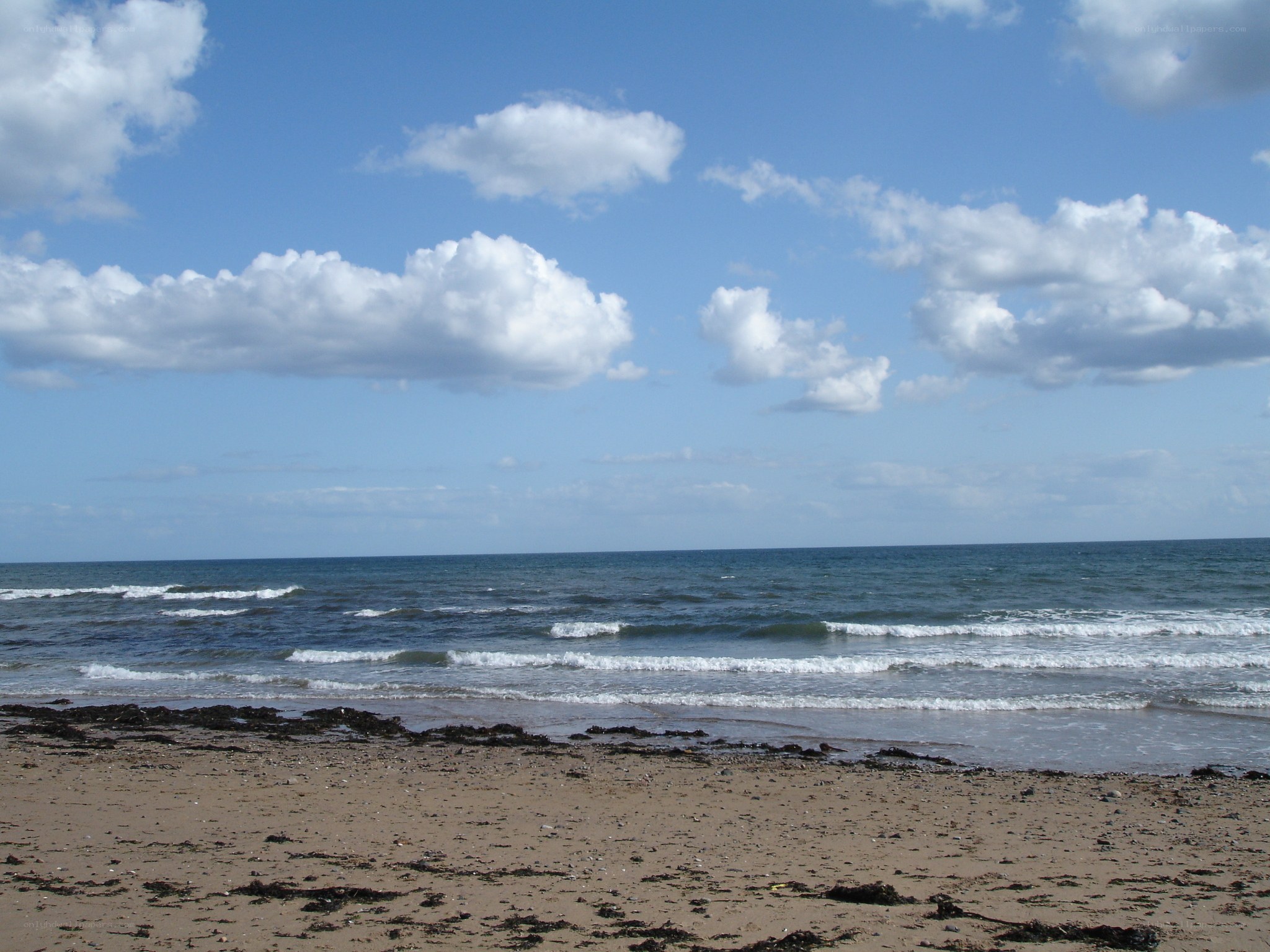 beach with waves and clouds