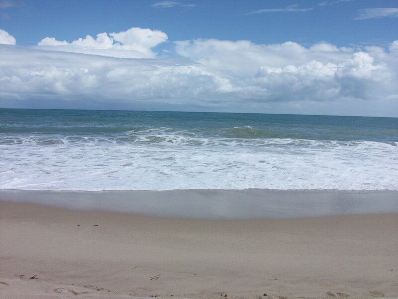 beach with waves and clouds