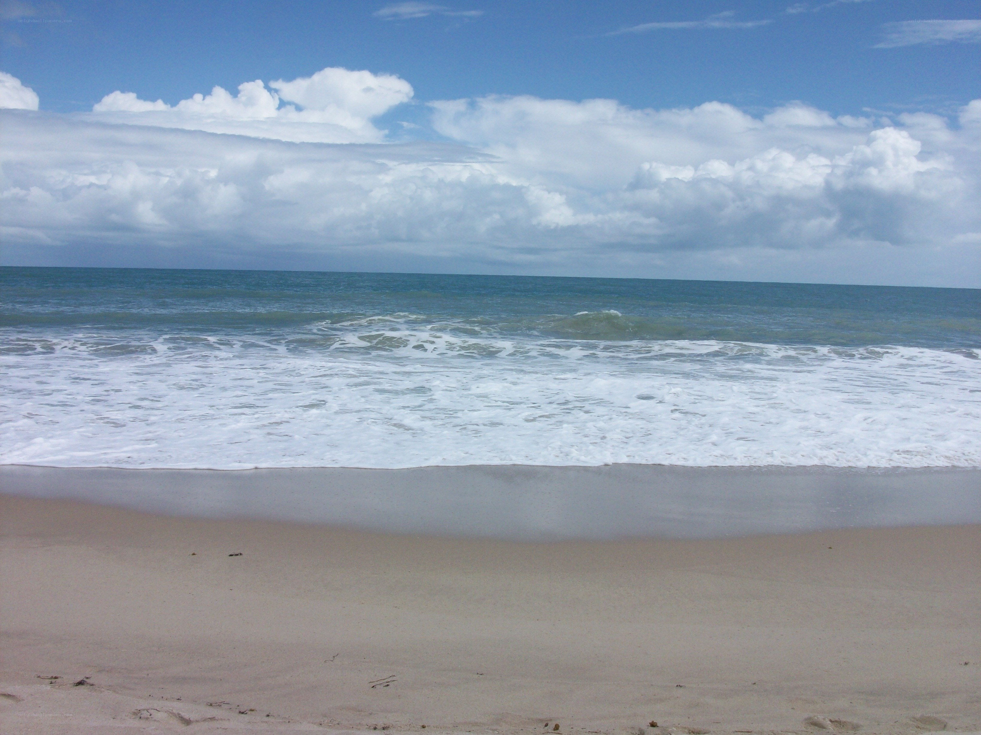 beach with waves and clouds