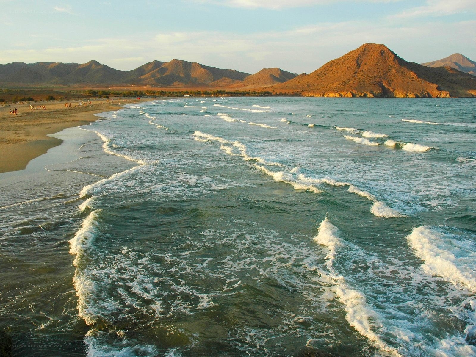 beach with waves and mountains