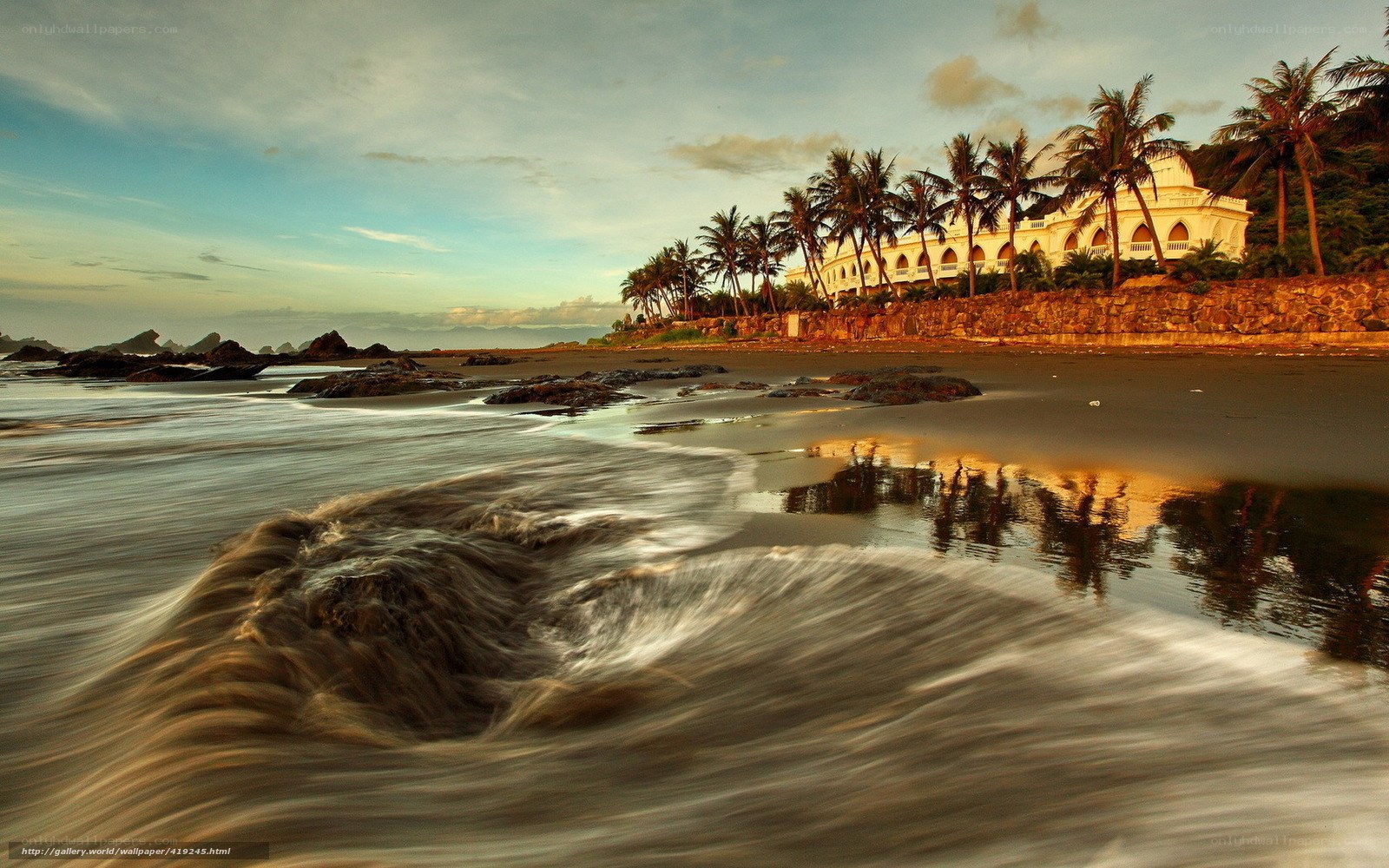 Beach with white building at sunset