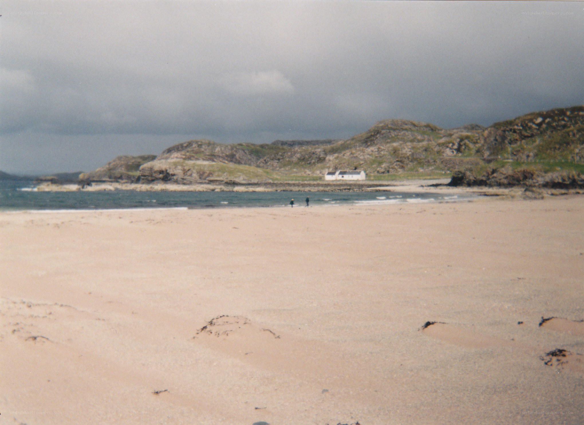 beach with white house on hill