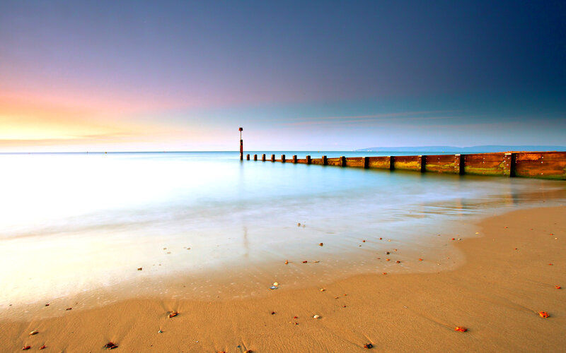 Beach with Wooden Pier — Blue, Serene, Sunset