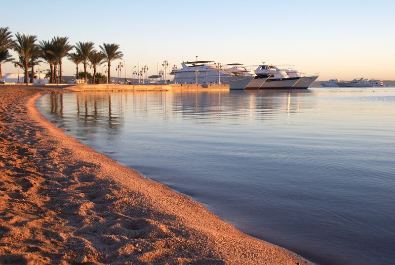 Beach with yachts at sunset