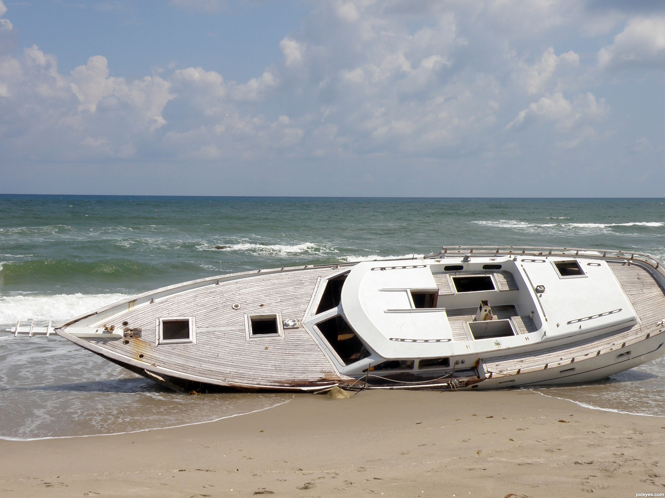 Beached boat on sandy shore