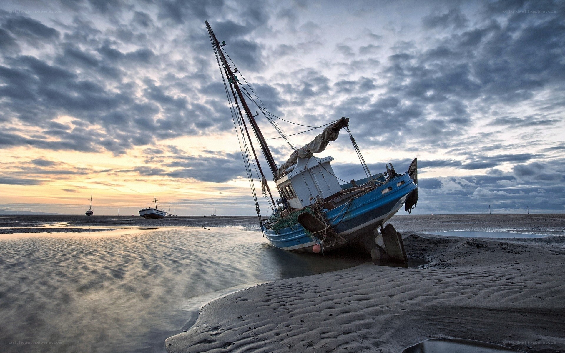 Beached fishing boat at sunset