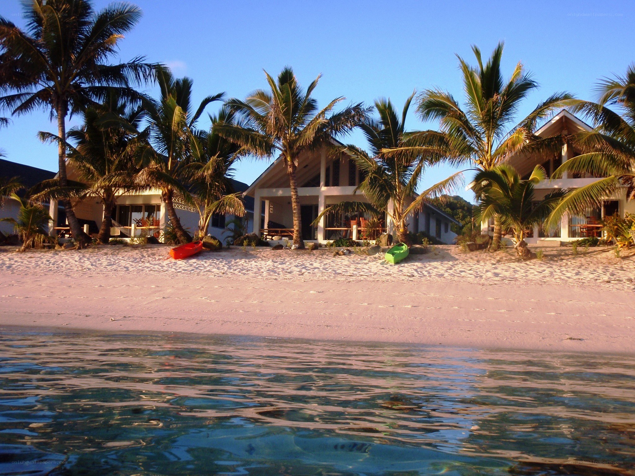 Beachfront bungalows at sunset
