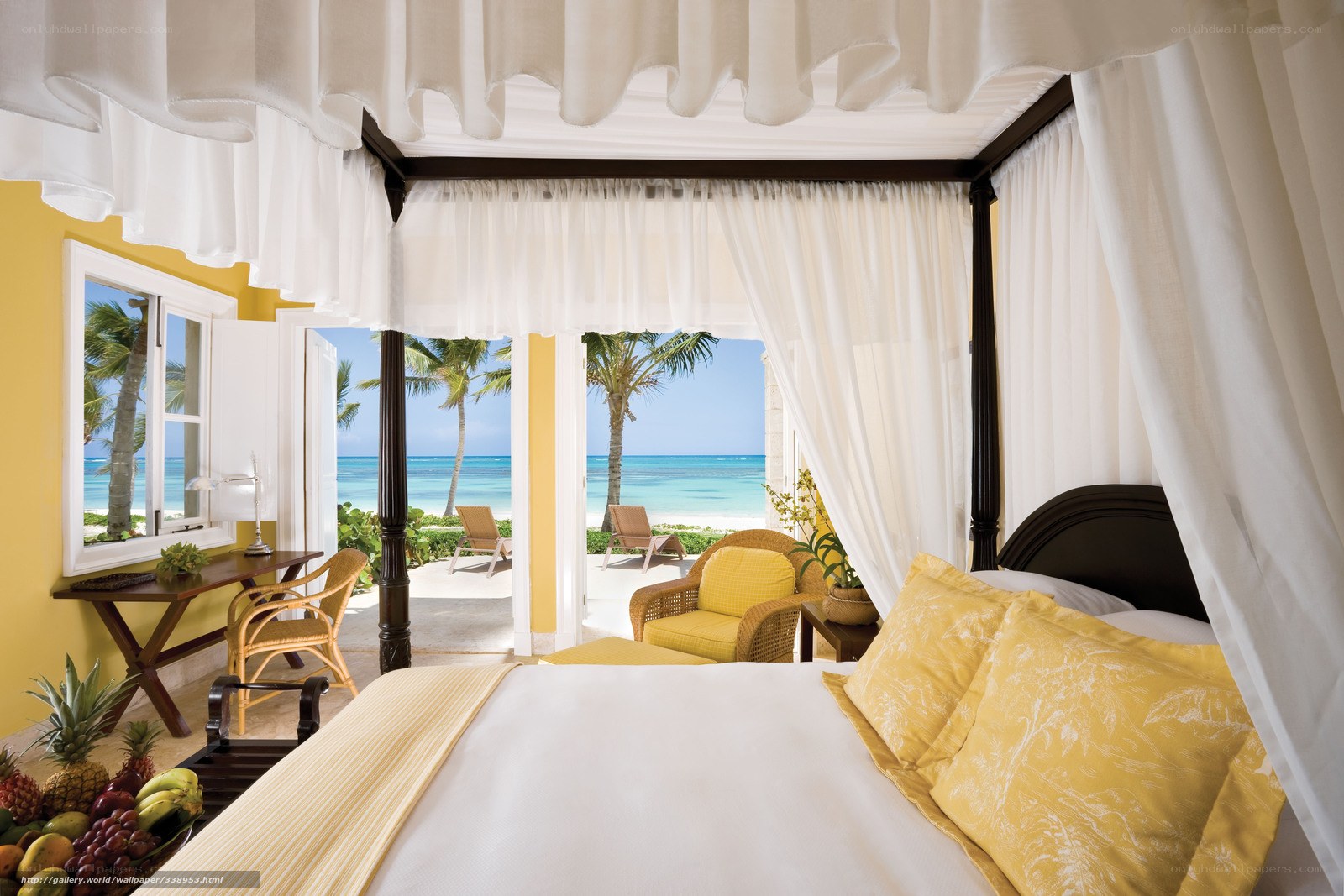 Beachfront hotel room with canopy bed