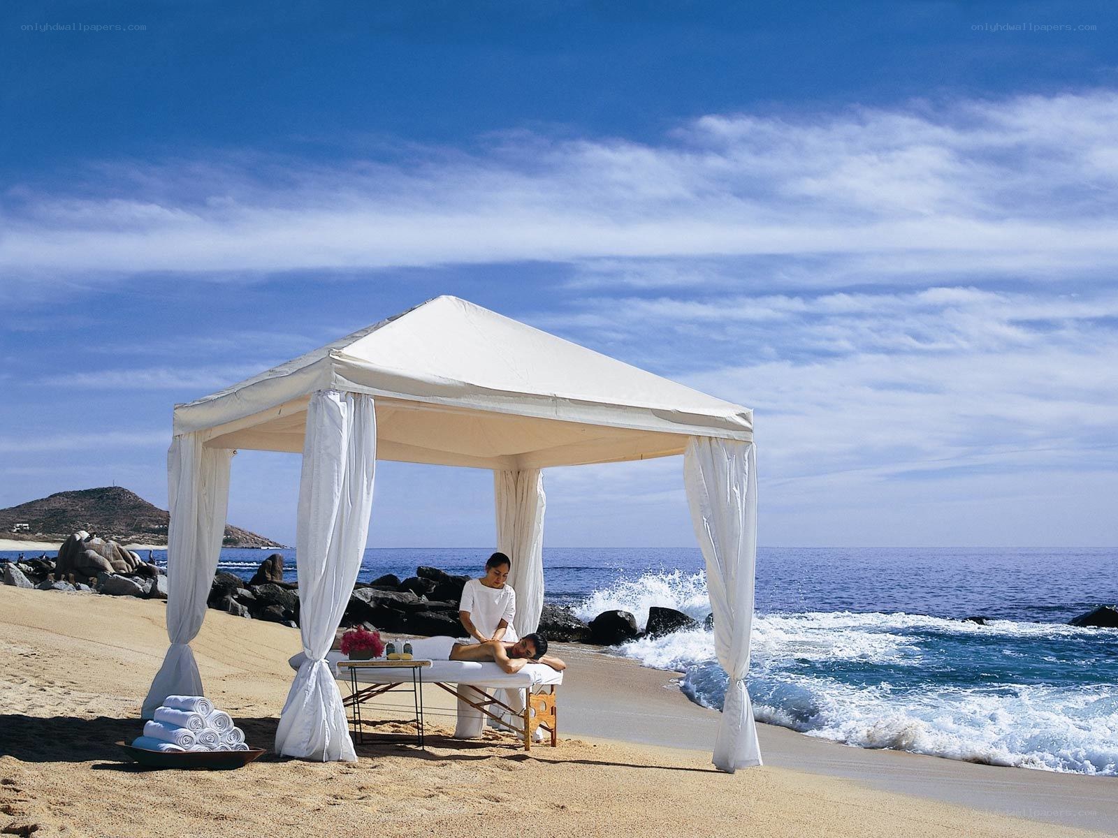 Beachside massage under canopy