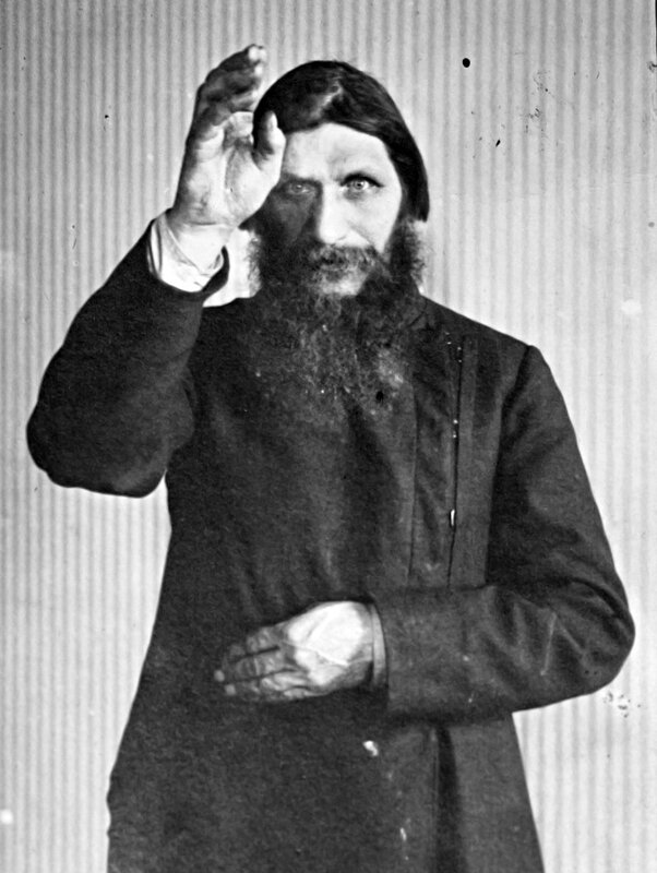 Bearded man in coat gesture